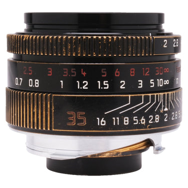 Leica 35mm f2 Summicron-M ASPH front three-quarter view showing aperture and distance scales with brassing