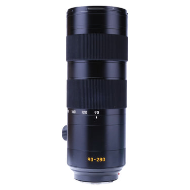 Leica 90-280mm f2.8-4 SL lens standing upright, front three-quarter view with hood