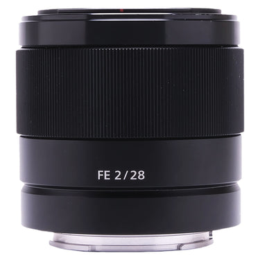 Sony FE 28mm f2 lens side view showing focus ring and FE 2/28 marking
