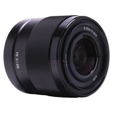 Sony FE 28mm f2 lens angled front view showing front element and 49mm filter thread