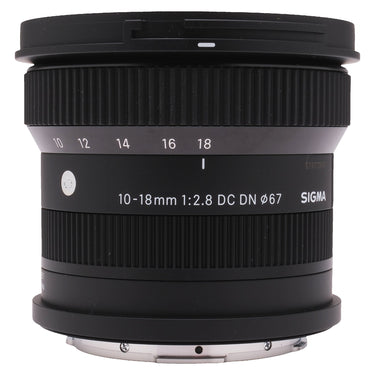 Sigma 10-18mm f2.8 DC DN lens side view with zoom scale and front cap mounted