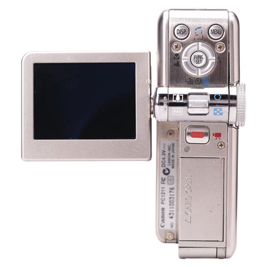 Canon PowerShot TX1 rear controls, open LCD screen and body serial label