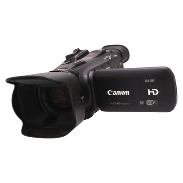 Canon XA20 front three-quarter view with lens hood and LCD panel showing XA20 badge