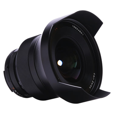 Carl Zeiss 15mm f2.8 Distagon ZF.2 angled front view with hood and Carl Zeiss T* markings