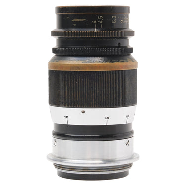 Leica 9cm f4 Elmar lens standing upright, aperture scale at top and screw mount base at bottom
