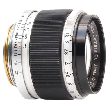 Canon 50mm f1.8 three-quarter side view of black barrel and aperture ring