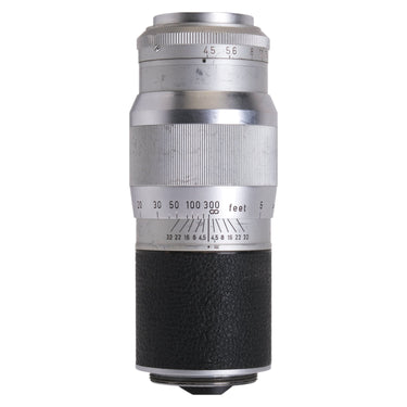 Leica Hektor 13.5cm f4.5 lens standing upright showing aperture scale and focusing barrel