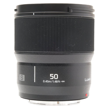 Panasonic Lumix S 50mm f1.8 lens standing upright with hood mounted and bare rear mount