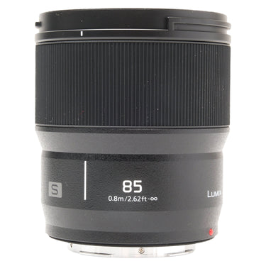 Panasonic Lumix S 85mm f1.8 lens standing upright with hood mounted, showing 85 focus distance markings