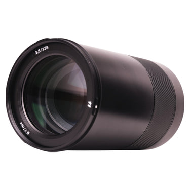 Hasselblad XCD 135mm f2.8 lens on its side showing front element and barrel