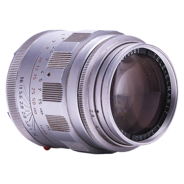 Leica 90mm f2.8 Tele-Elmarit angled view showing front element and engraved serial 2070681