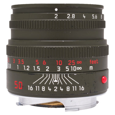 Leica Summicron-M 50mm f2 Safari front-quarter view, aperture and focus scales, red index and paint wear on olive barrel