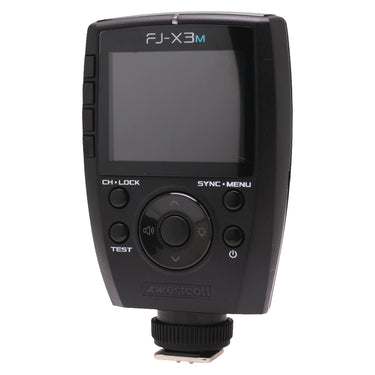 Westcott FJ-X3m flash trigger front view showing LCD screen, control dial, and side buttons