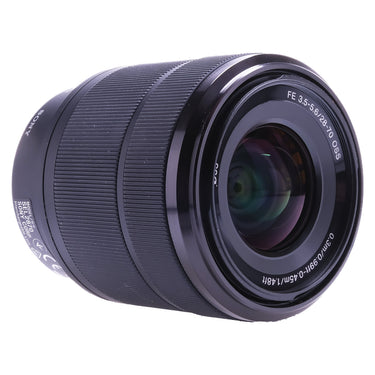 Sony FE 28-70mm OSS lens angled front view showing front glass and Sony marking