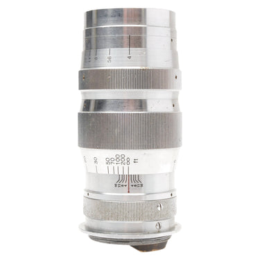 Canon 135mm f4 Serenar lens standing upright showing aperture and distance scales with bare mount at base