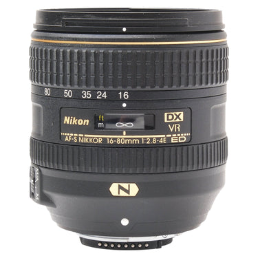 Nikon AF-S 16-80mm f2.8-4E ED VR DX lens front three-quarter view showing focal length scale and markings