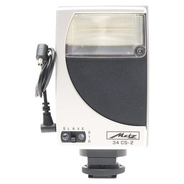 Metz Mecablitz 34 CS-2 flash front view with flash tube, slave switch, and attached sync cable