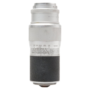 Leica Hektor 13.5cm f4.5 lens standing upright, silver barrel with aperture and focus scales