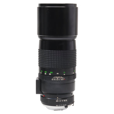 Minolta 300mm f4.5 MC Tele Rokkor-X lens side view with hood extended and focus scale