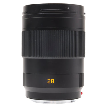Leica 28mm f2 APO-Summicron-SL standing upright with bayonet hood mounted and focus ring visible