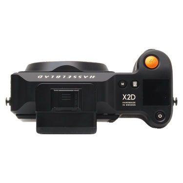 Hasselblad X2D 100C top plate showing X2D marking, orange shutter button, and hot shoe