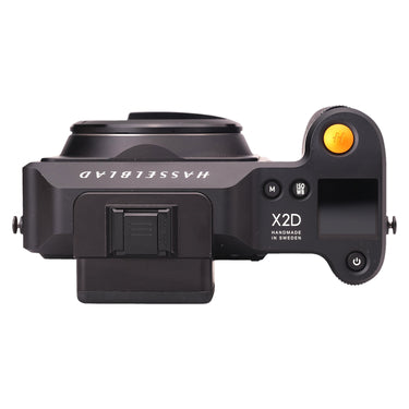 Hasselblad X2D 100C top plate with X2D marking, ISO/WB and M buttons, and orange shutter button