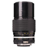 Nikon 200mm f4 AI Nikkor lens standing upright showing barrel engraving, serial number, and aperture ring