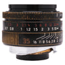 Leica 35mm f2 Summicron-M ASPH front three-quarter view showing aperture and distance scales with brassing