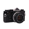 Olympus OM-1 black with Zuiko 50mm f1.8 lens, front three-quarter view