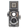 Rollei 4x4 Baby grey TLR front view with Xenar taking lens, Heidosmat viewing lens and Rolleiflex nameplate