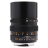 Leica 90mm f2.8 Elmarit-M lens front three-quarter view with aperture scale and built-in hood extended