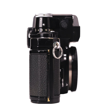 Nikon F2 Photomic black left side showing edge brassing and strap lug