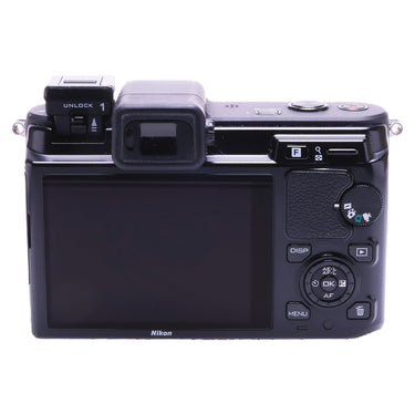 Nikon 1 V1 rear view showing LCD screen, viewfinder and control dial