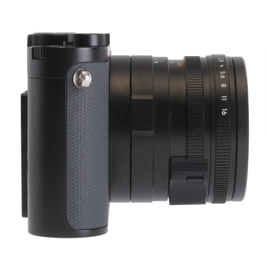 Camera West Leica Q3 43 digital camera in black, side profile view showing lens aperture ring and textured grip.