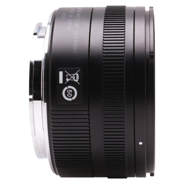 Leica Summicron-TL 23mm f2 side profile showing recycling symbol and control rings