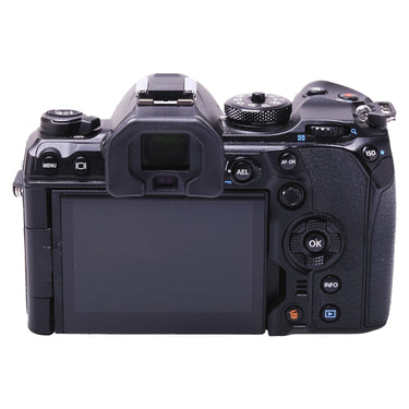 Olympus OM-1 rear view showing EVF, tilting screen and control buttons