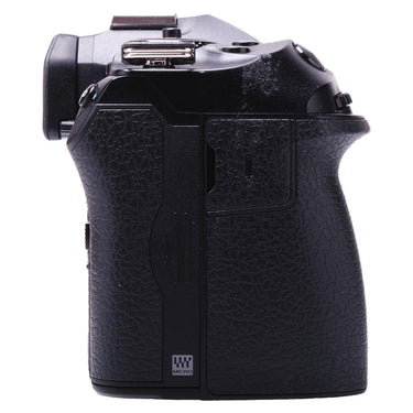 Olympus OM-1 right side showing card compartment door and grip