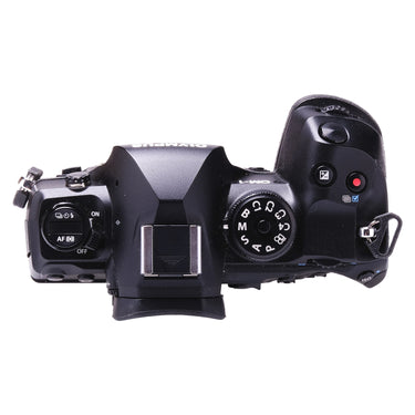 Olympus OM-1 top plate with mode dial, hot shoe and controls