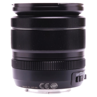 Fujifilm XF 18-55mm side view showing focus and zoom rings and OIS switch