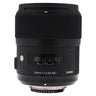 Sigma 35mm f1.4 DG Art front-quarter view with hood mounted, distance scale and serial number