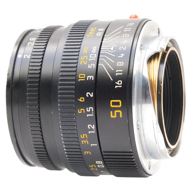 Leica 50mm Summicron-M rear three-quarter view showing mount and depth of field scale