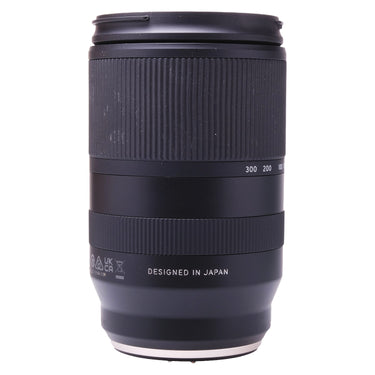 Tamron 18-300mm lens side view showing zoom scale and Designed in Japan marking