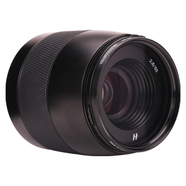 Hasselblad XCD 65mm angled front three-quarter view with 67mm filter mounted