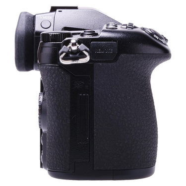 Panasonic Lumix DC-G9 left side showing SD card slot door and remote port