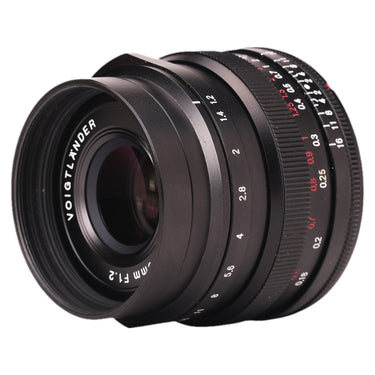 Voigtlander 23mm f1.2 Nokton angled front view with metal hood mounted