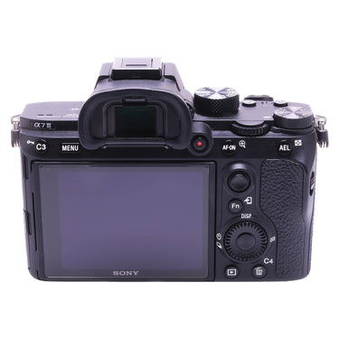 Sony A7 III rear view with LCD screen, viewfinder, and control buttons