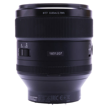 Sony FE 85mm F1.4 GM side showing serial number, aperture click switch and 77mm marking