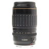 Canon EF 100-300mm USM lens standing upright with front cap and mount cap fitted