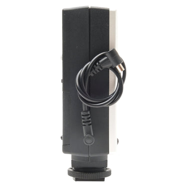 Metz Mecablitz 34 CS-2 flash side view with coiled PC sync cable and plug