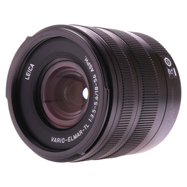 Leica Vario-Elmar-TL 18-56mm lens front three-quarter view showing front element and model engraving